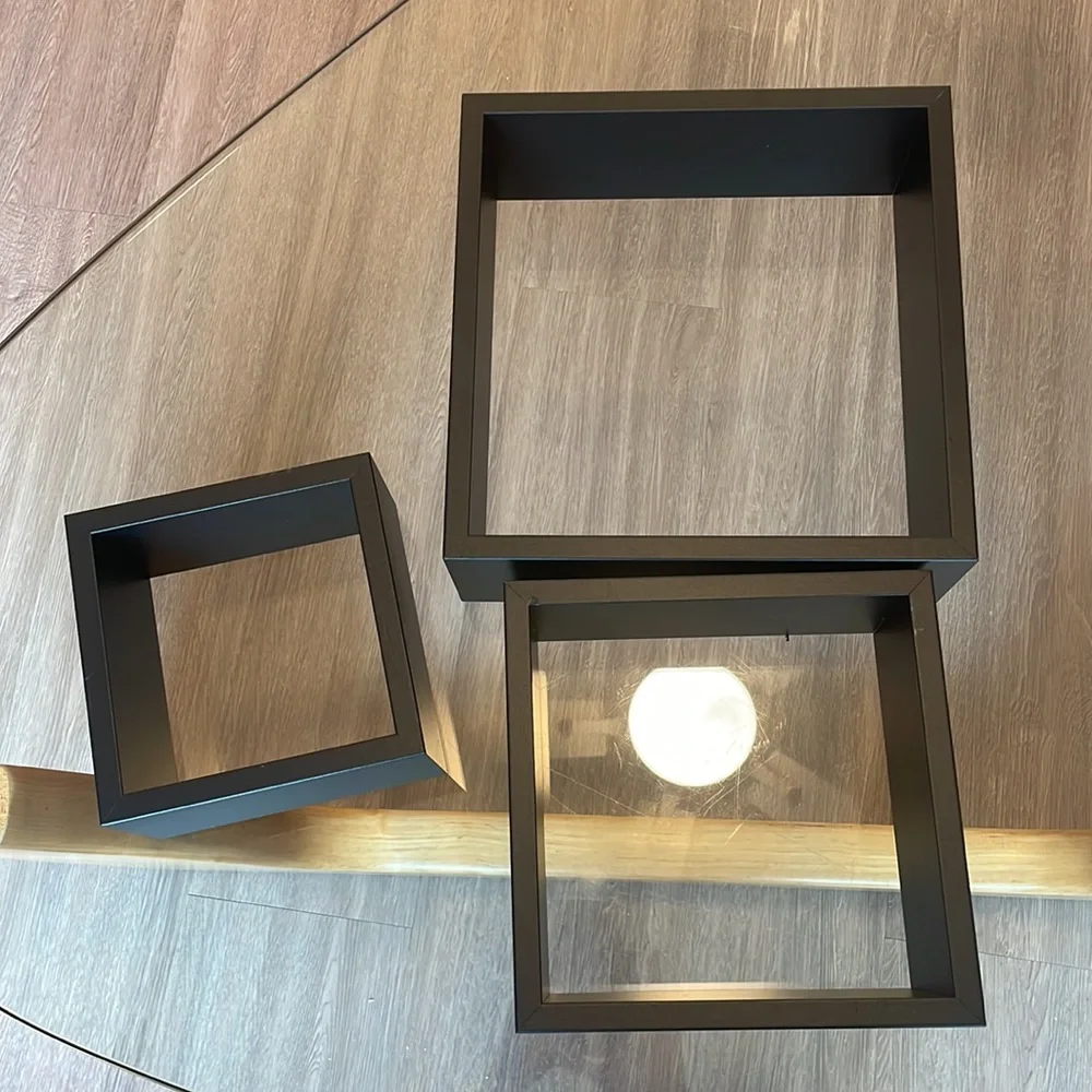 3 black shelving units